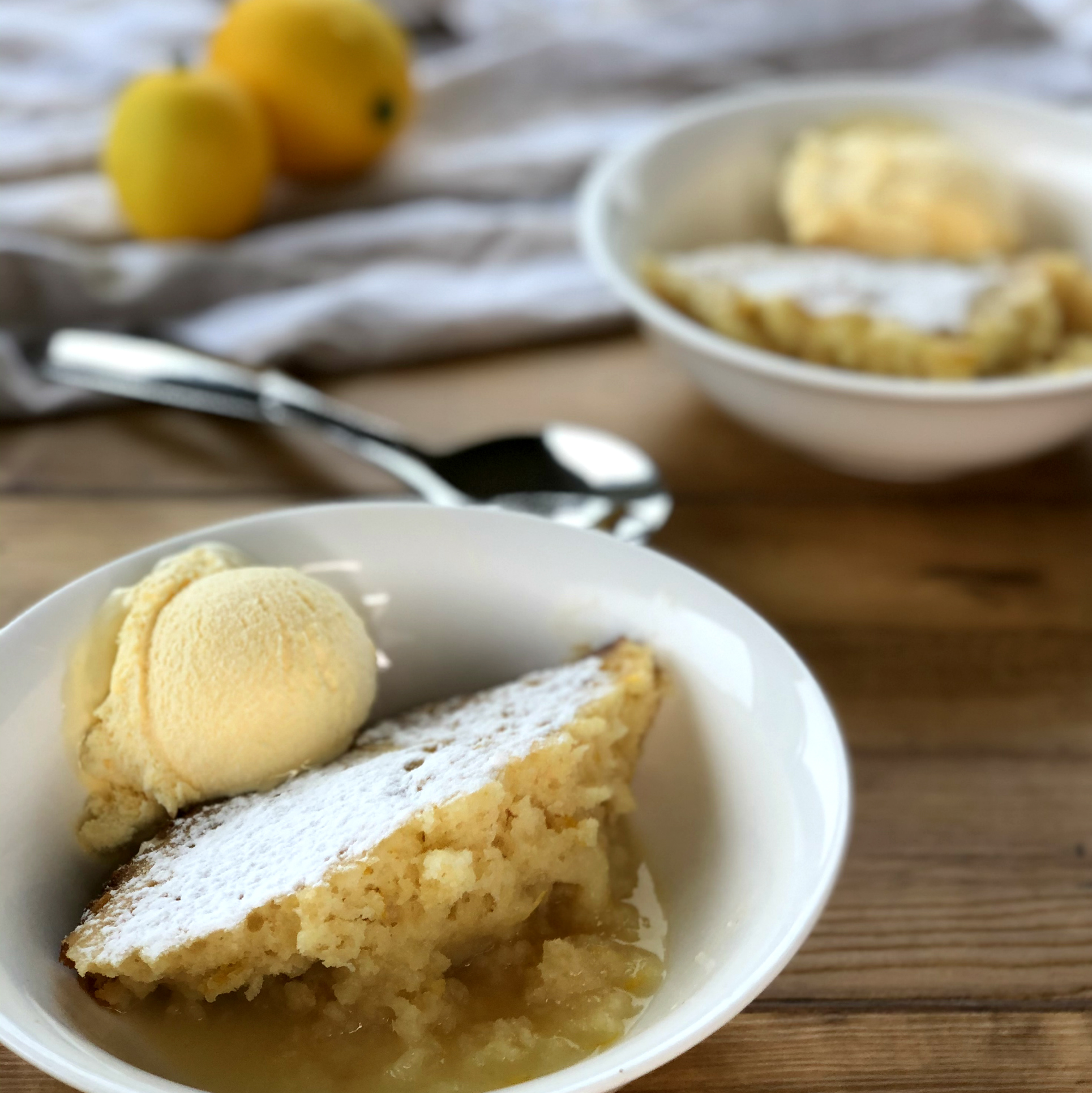 Two bowls with Lemon Self Saucing Pudding and ice cream 