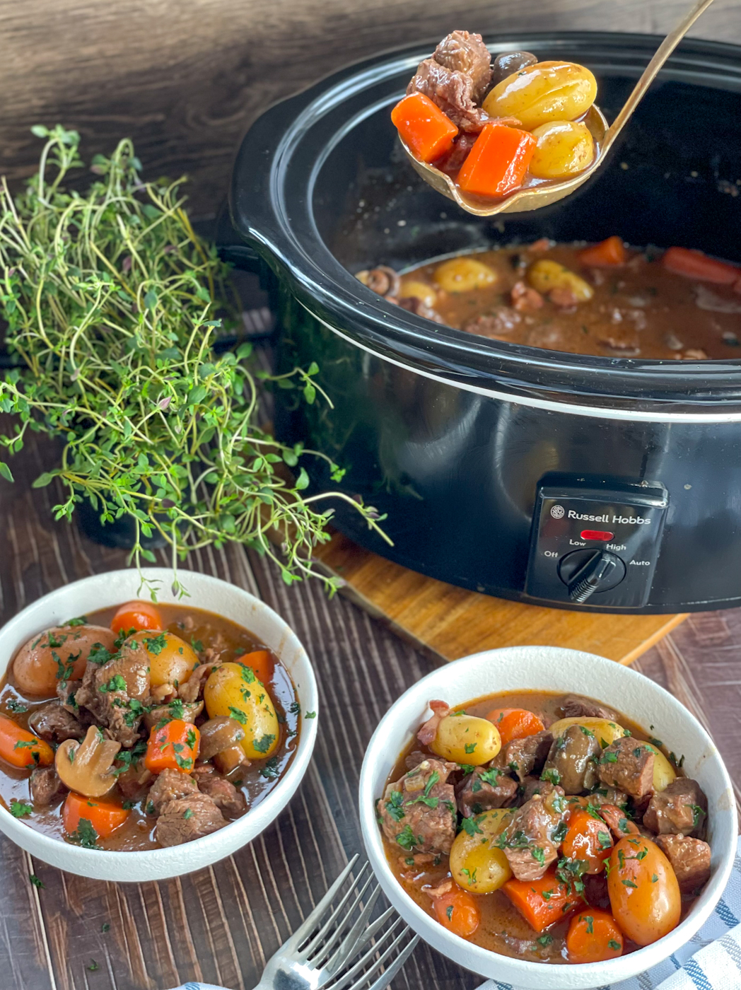 Slow cooker full of Beef Bourguignon with vegetables