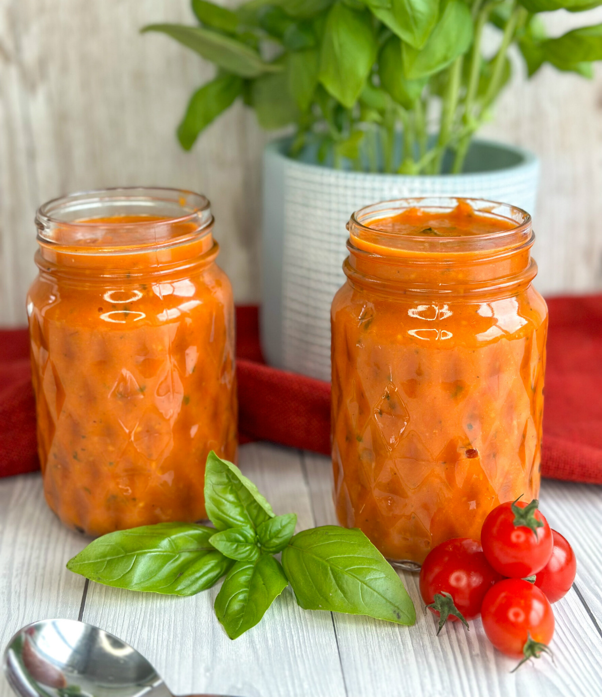 Glass jars filled with homemade pasta sauce - cherry tomato and basil slow cooker pasta sauce 