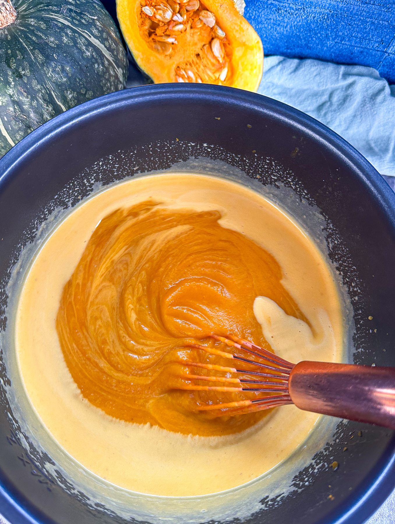 Whisking the cream through the pumpkin soup made in the slow cooker until smooth and creamy