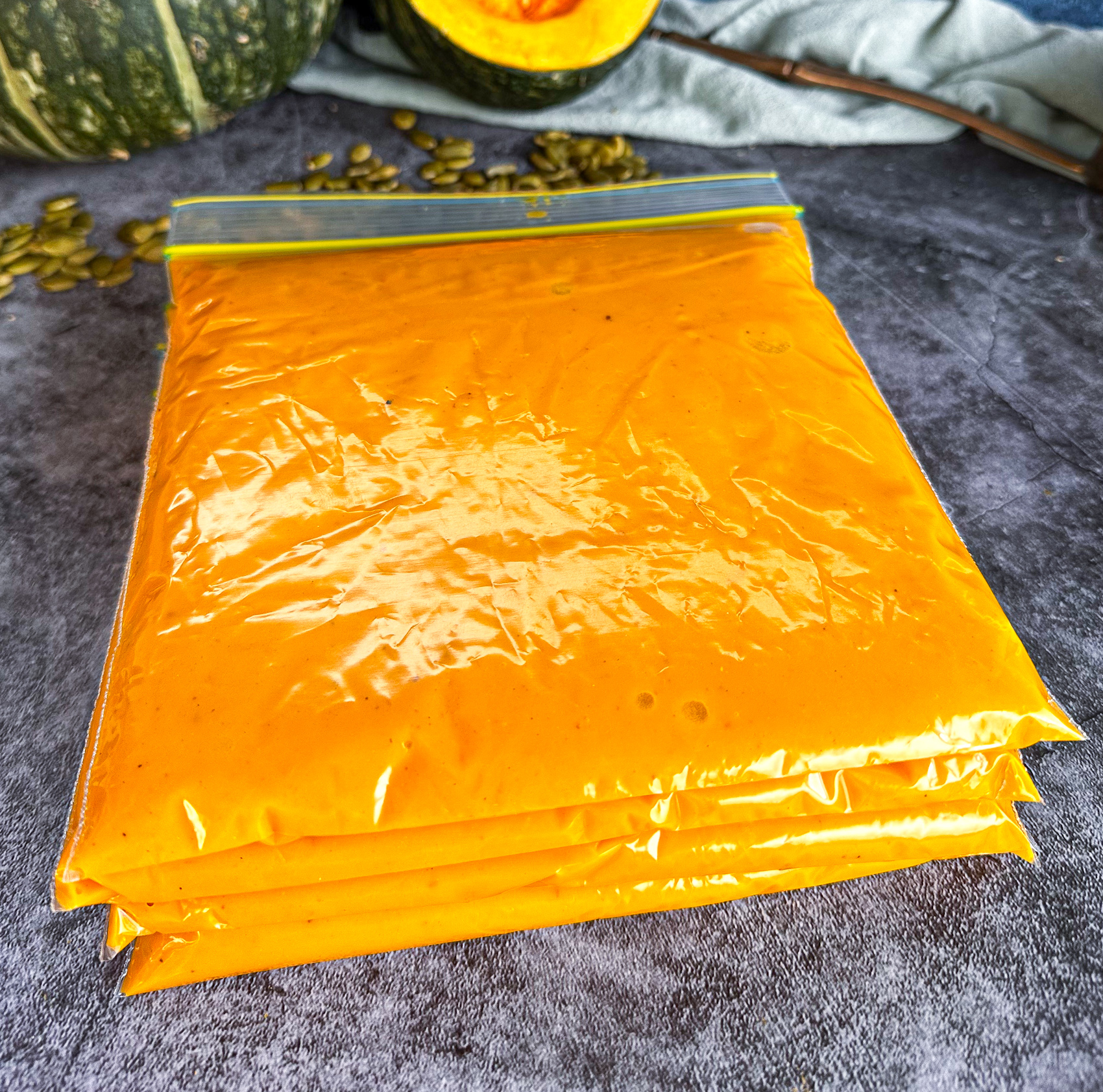 Freezer snaplock bags filled with soup and layed flat