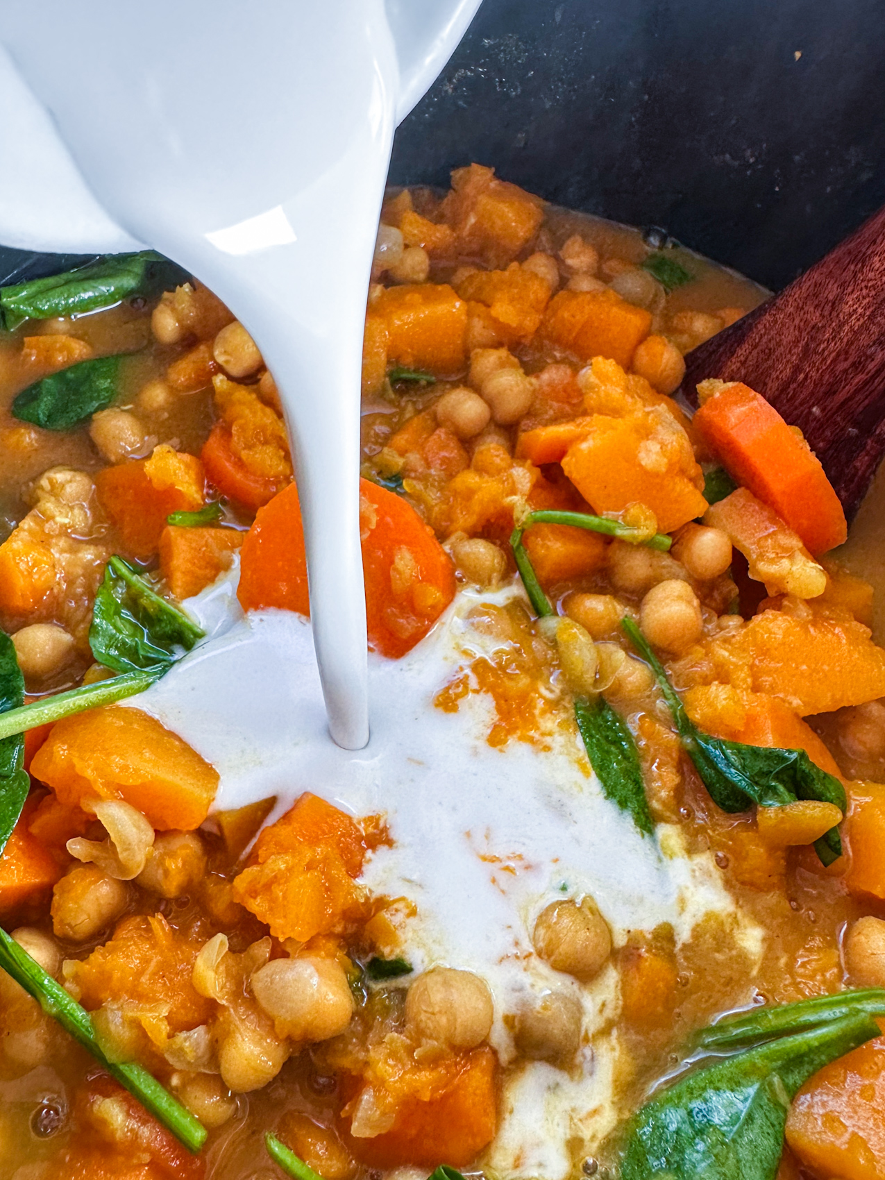 Pouring coconut cream into the slow cooker