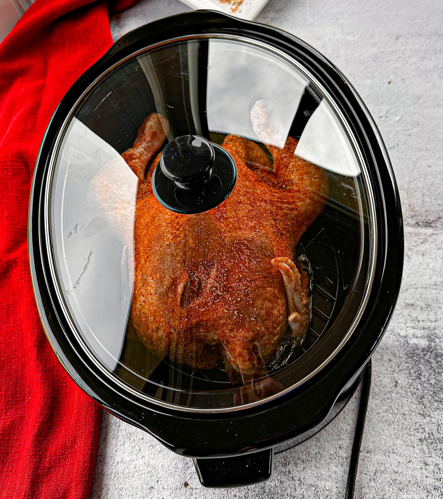 Spice rubbed whole chicken in a slow cooker