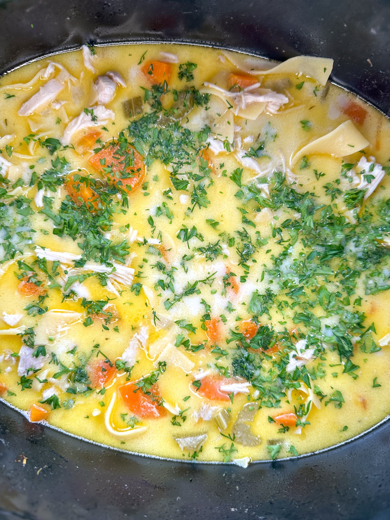 Cozy Creamy Slow Cooker Chicken Noodle Soup slow cooker soup with cream added and finished with fresh herbs and lemon juice