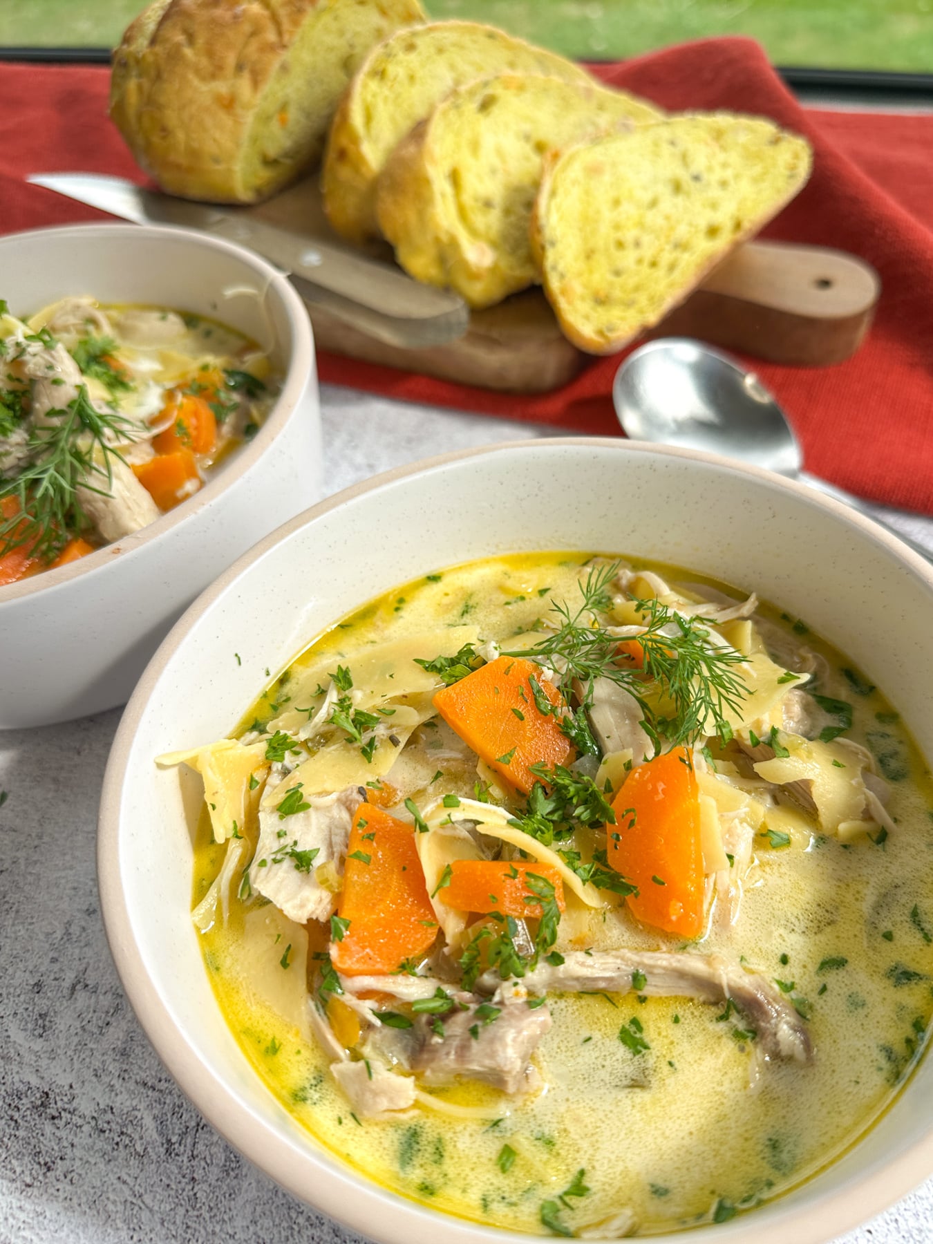 Cozy Creamy Slow Cooker Chicken Noodle Soup Creamy Slow Cooker Chicken Noodle soup in a bowl with crusty bread