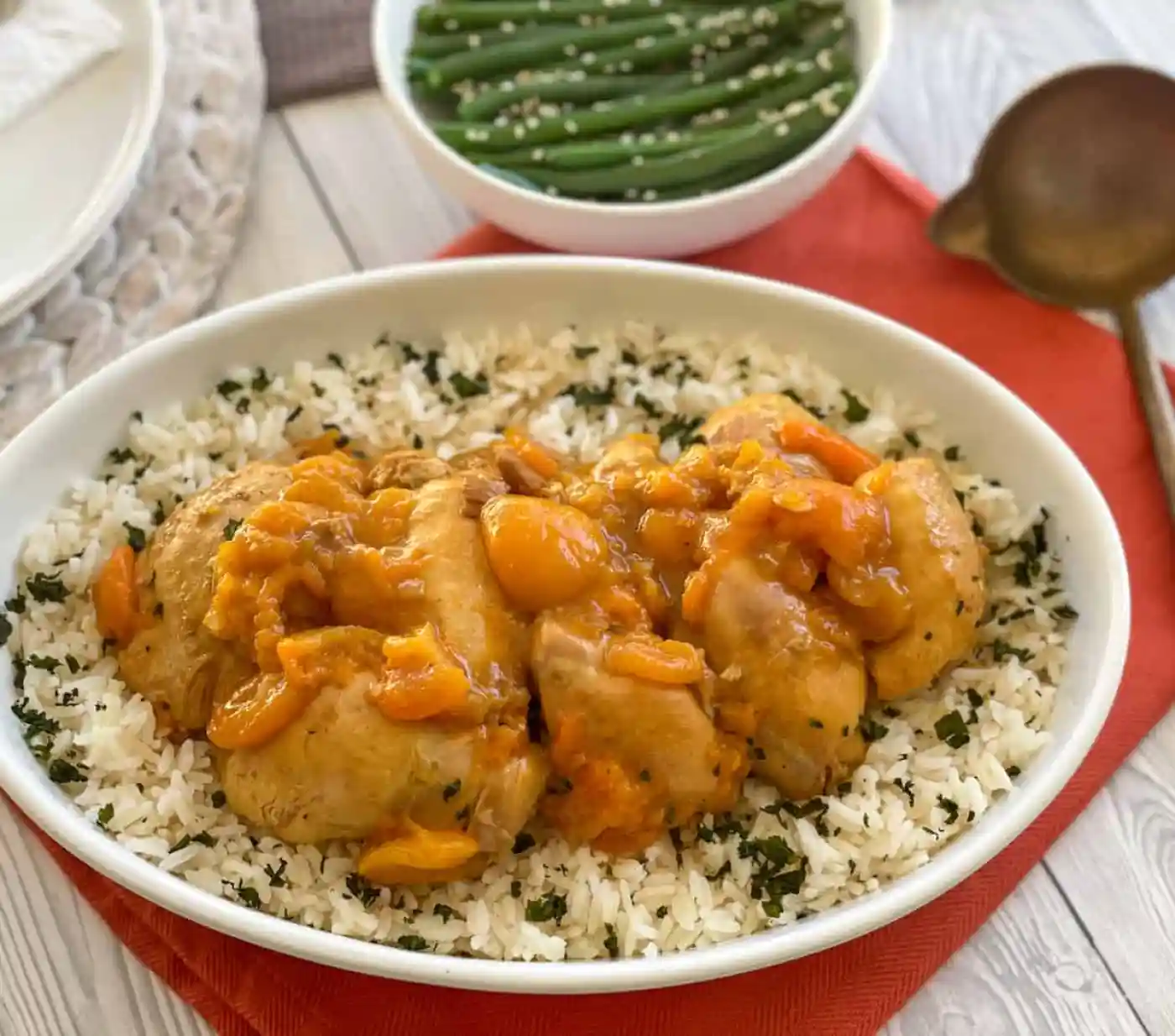 slow cooker apricot chicken in a bowl over rice.