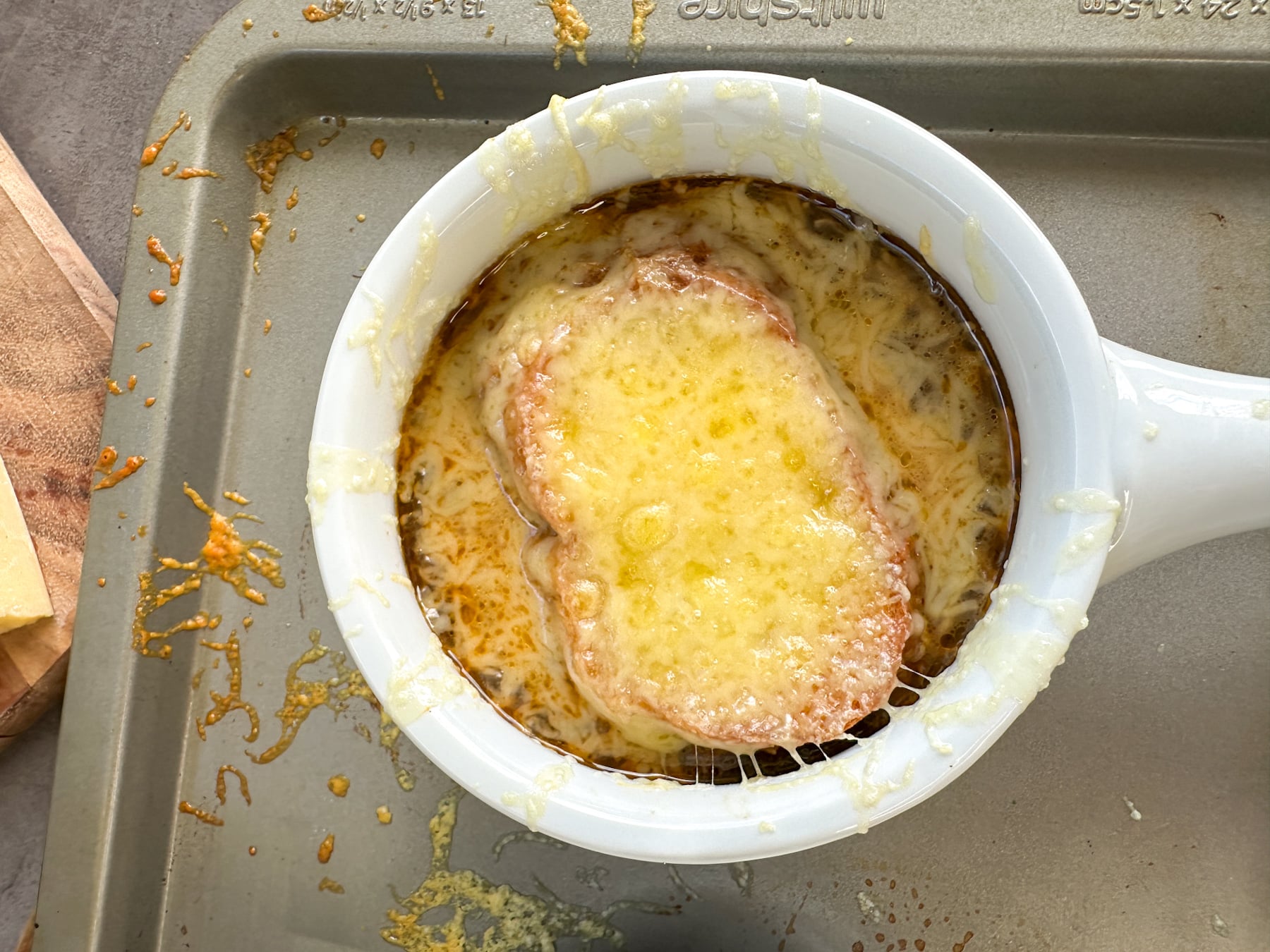 golden bubbling melted cheese on top of French onion soup