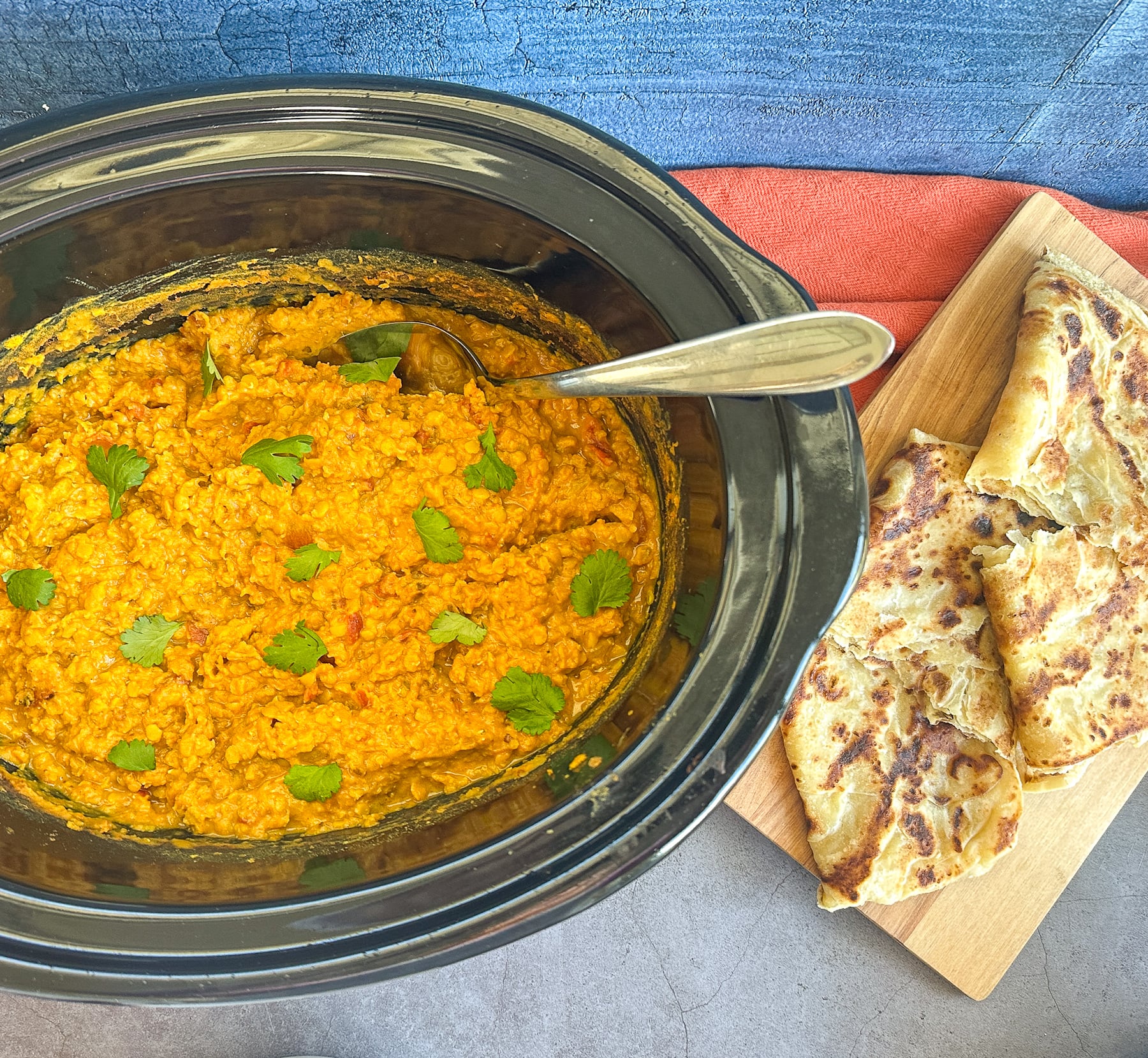 Slow cooker filled with creamy red lentil curry (dahl)