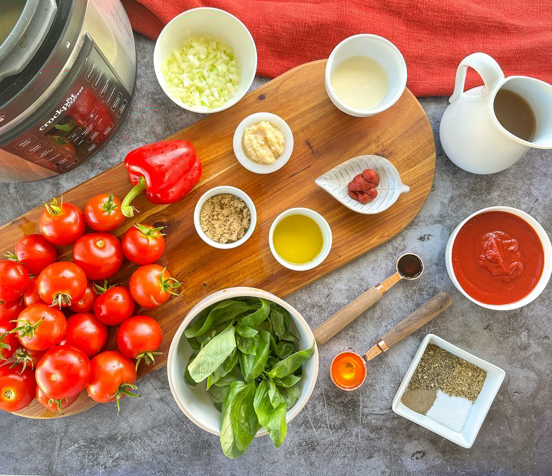 ingredients for slow cooker tomato basil soup including broth onions, pasta and bell peppers