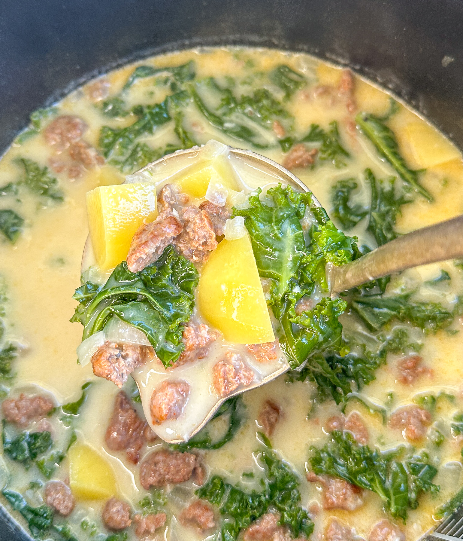 close up photo of a slow cooker full of slow cooked Zuppa Toscana
