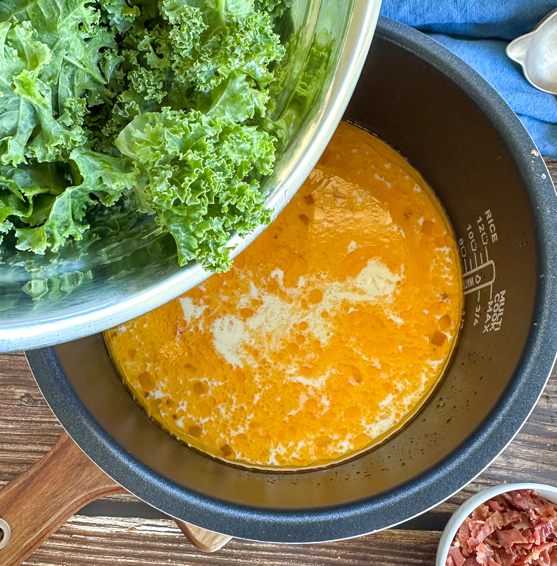 adding the kale to the slow cooker after the cream