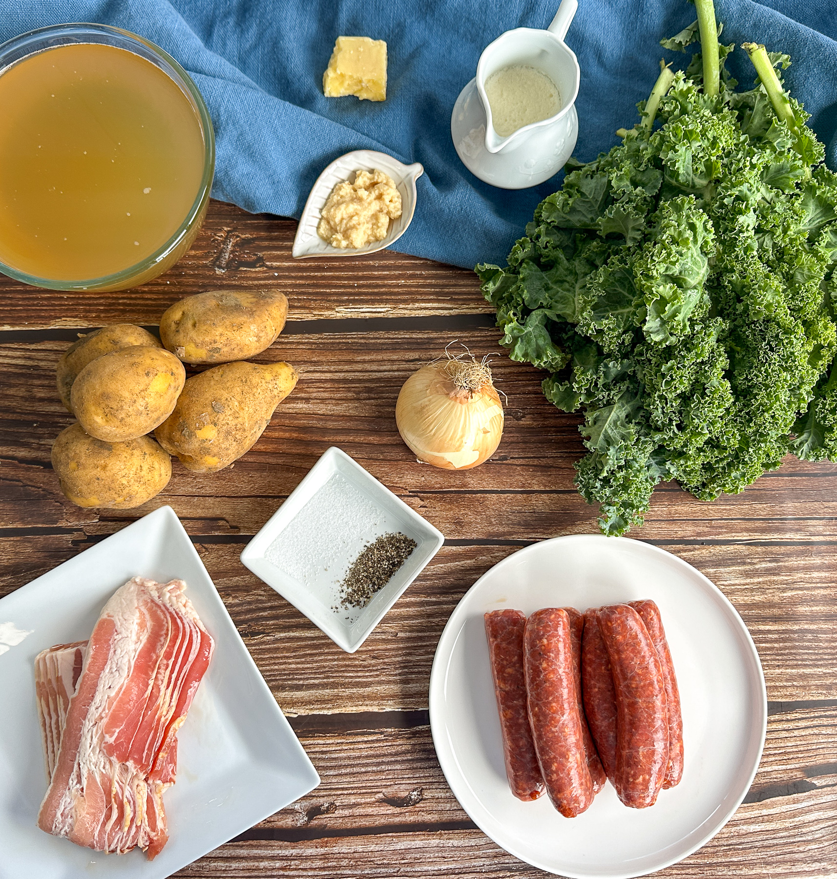 Ingredients used for Zuppa Toscana such as Italian sausage, streaky bacon, potatoes and kale