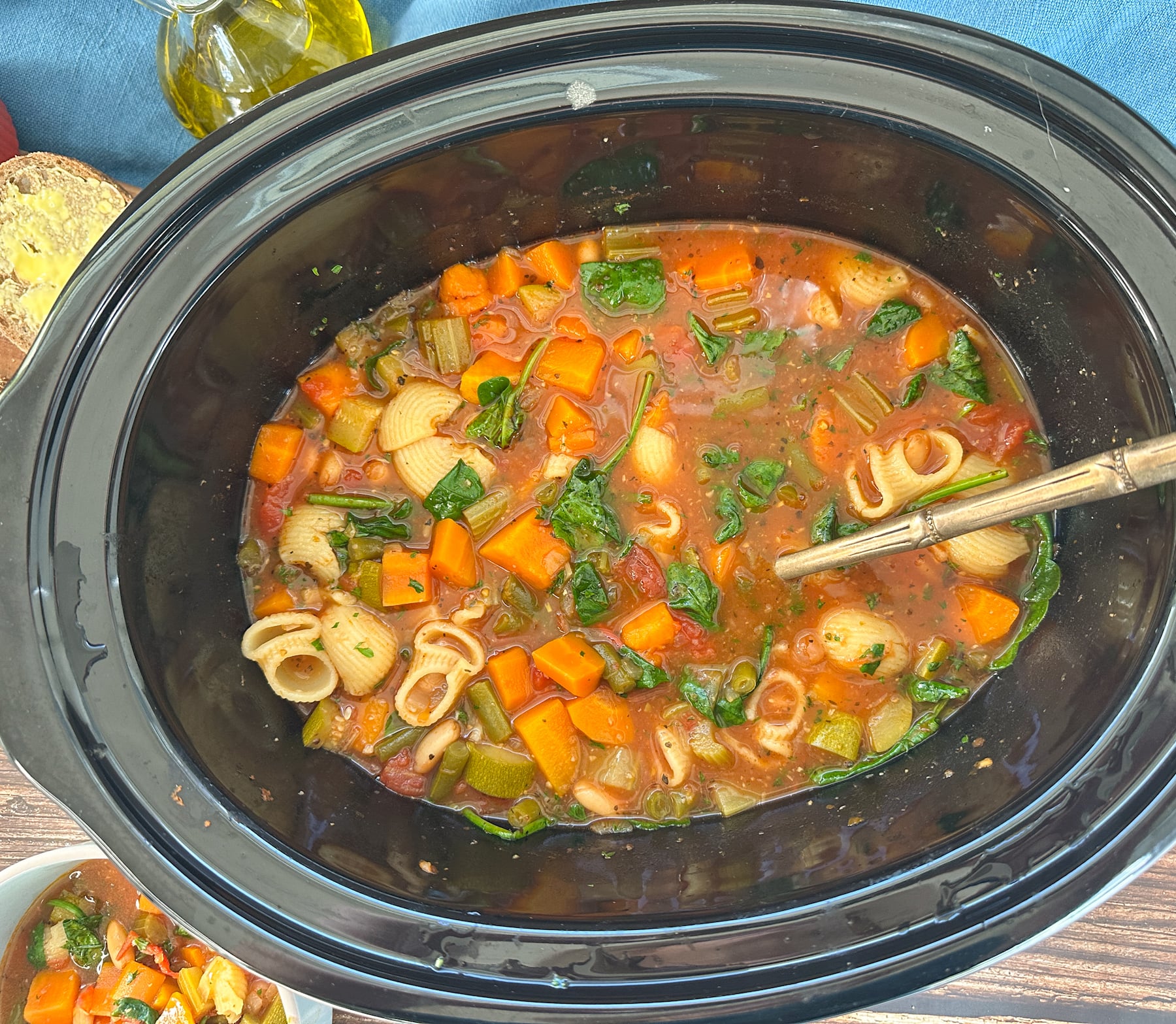 cooked minestrone with pasta and spinach mixed through