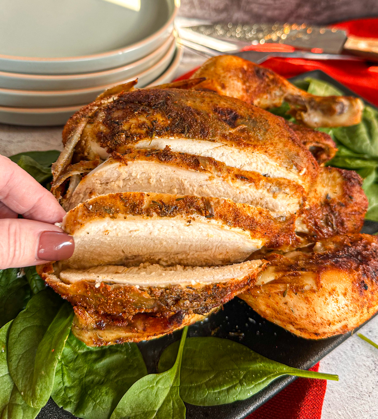 showing how tender the chicken breast is on the slow cooked chicken