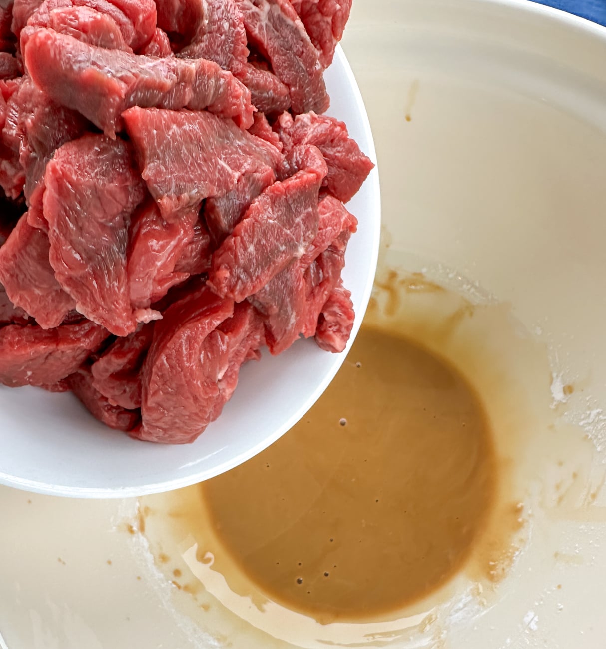adding the beef to the soy and cornflour to keep the beef tender