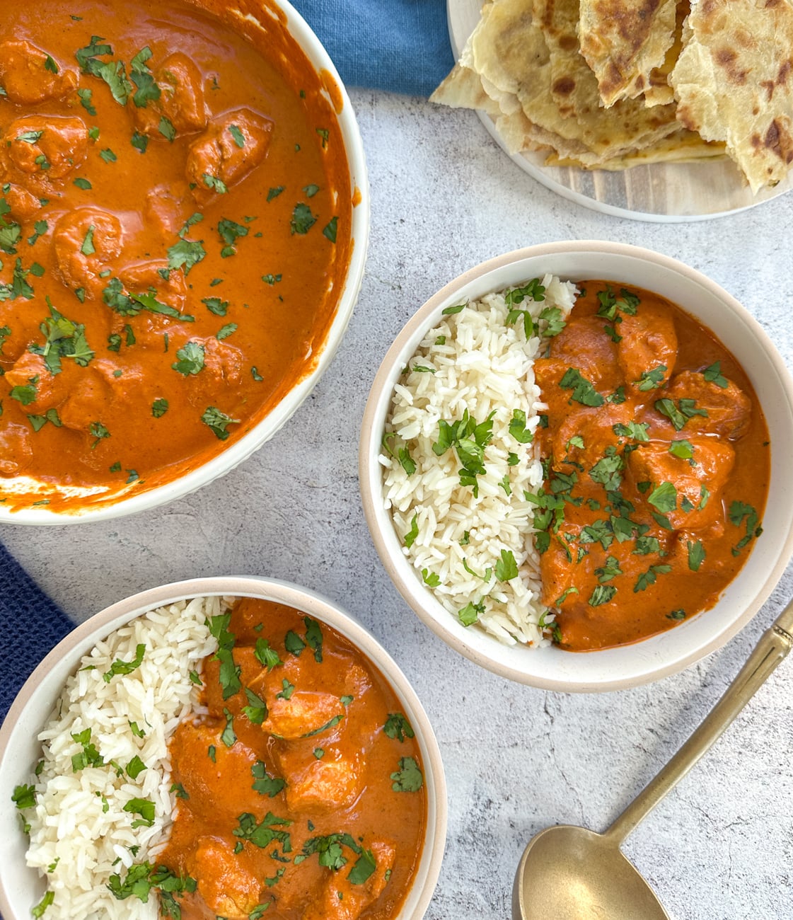 slow cooker butter chicken served in bowls with rice