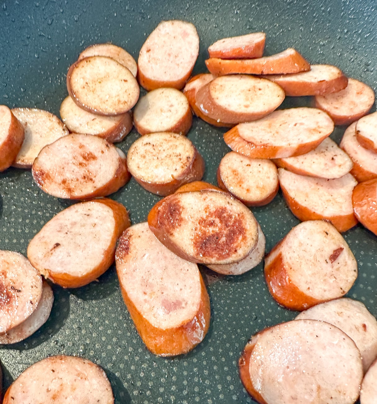 browning sliced Kransky sausage for the slow cooker jambalaya