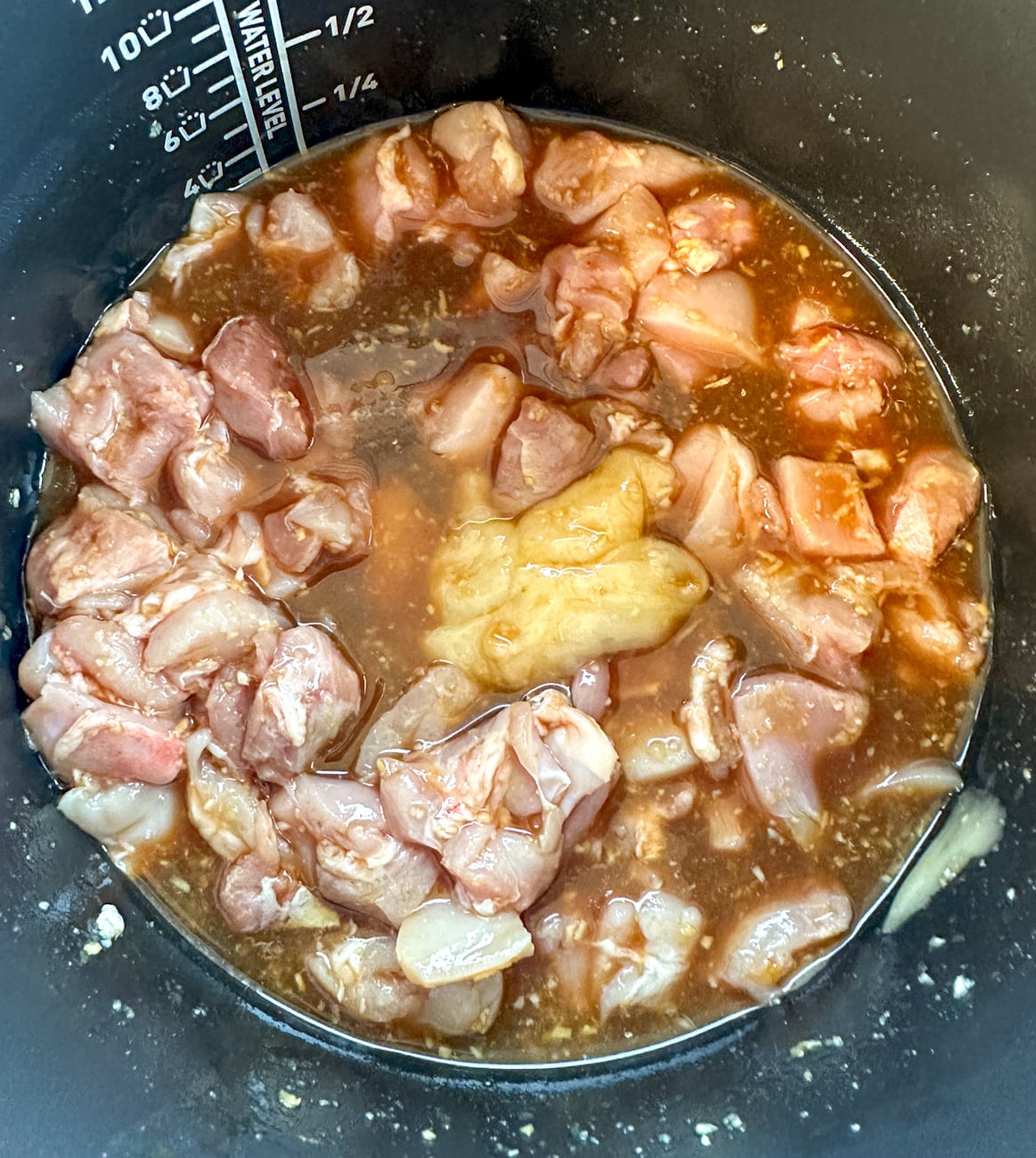 slow cooker filled with ingredients to make honey soy chicken