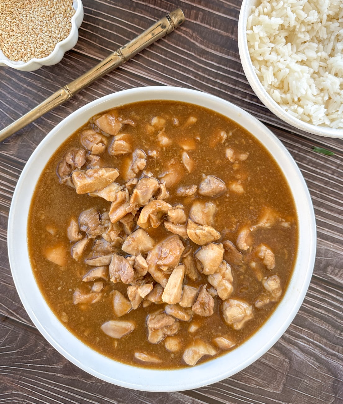 white serving bowl filled with honey soy chicken with sticky sauce