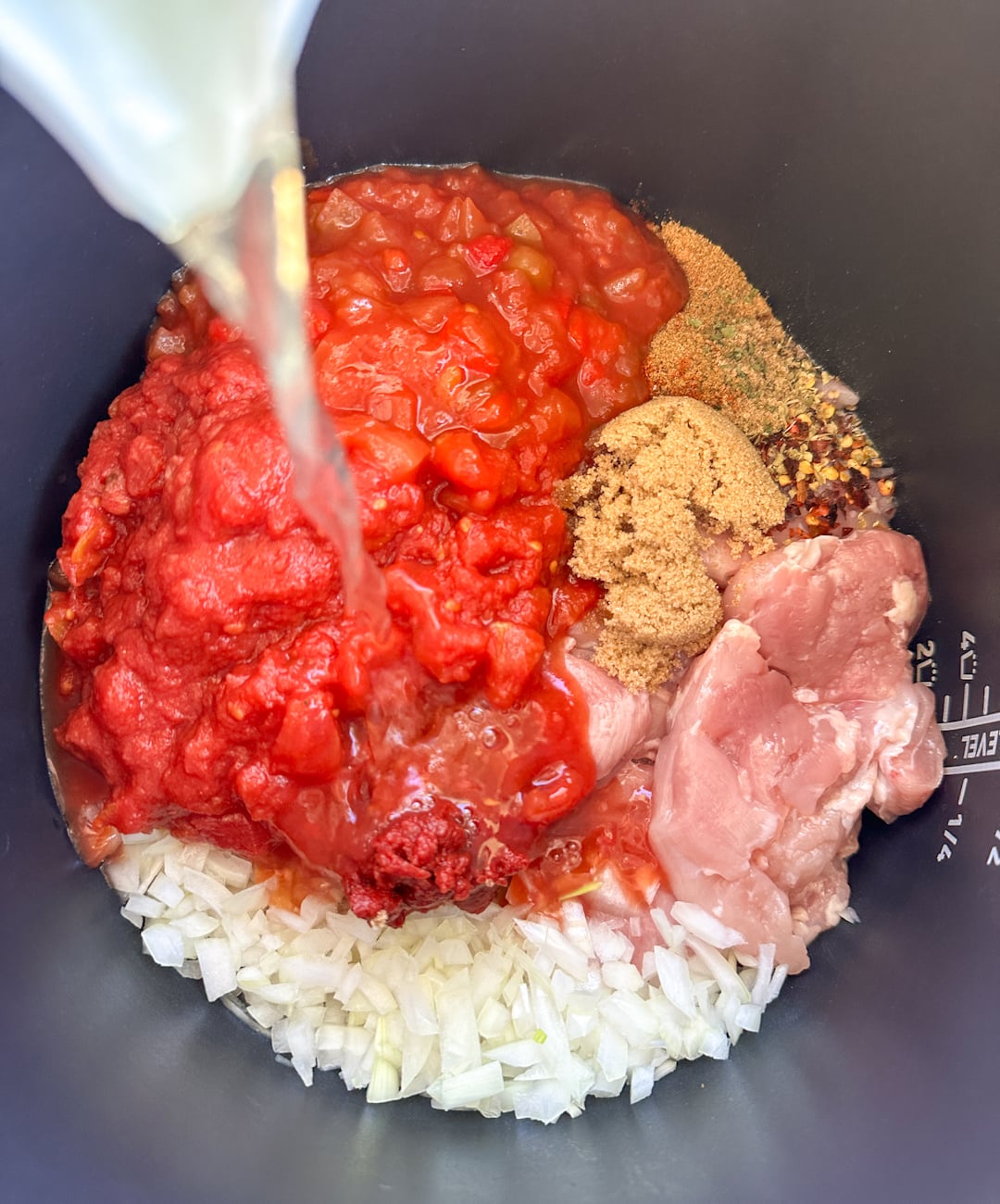 adding ingredients into the slow cooker