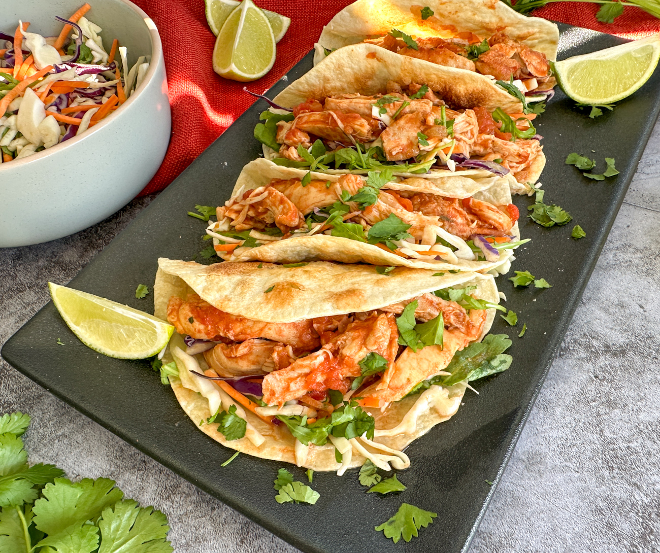 soft tacos with mexican shredded chicken, coleslaw and fresh herbs
