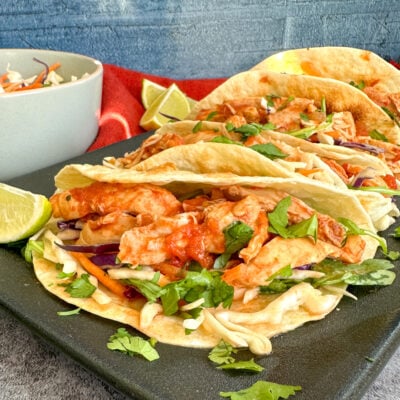 Slow Cooker Mexican Shredded Chicken on soft tacos