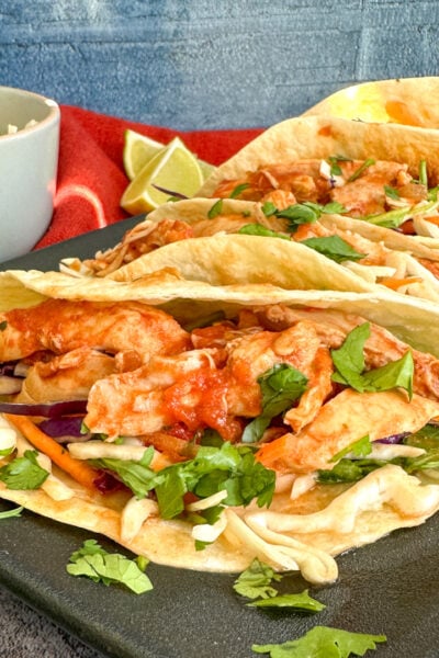 Slow Cooker Mexican Shredded Chicken on soft tacos