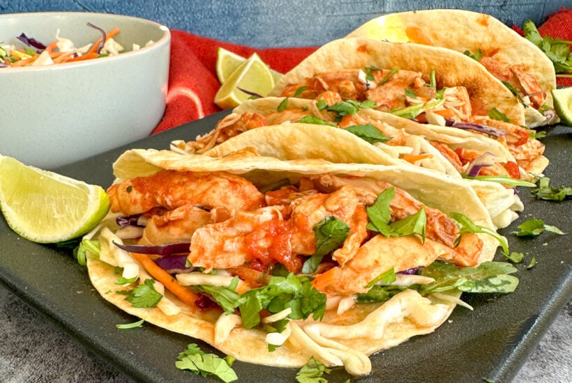 Slow Cooker Mexican Shredded Chicken on soft tacos