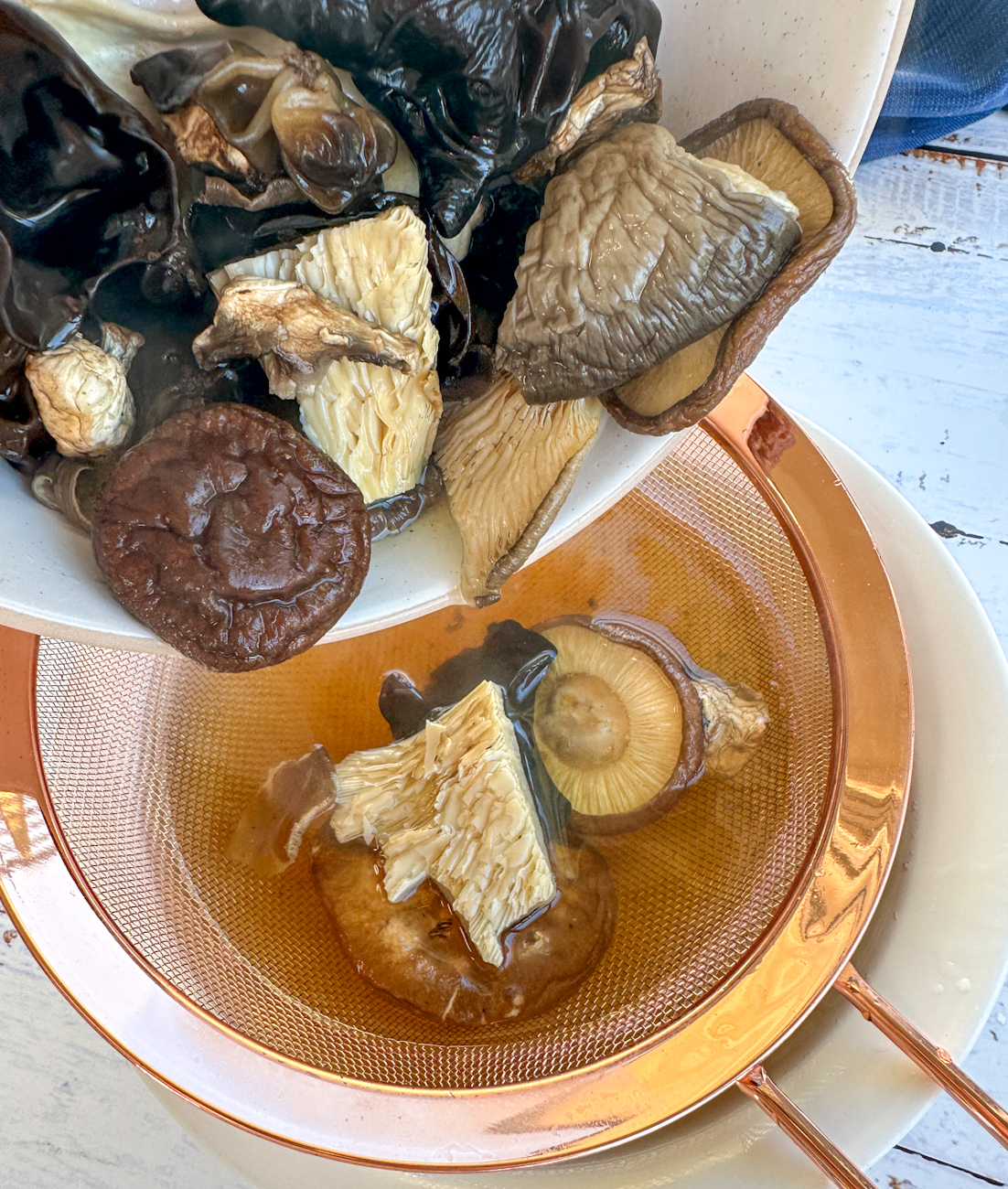 dried mushrooms being strained of their broth