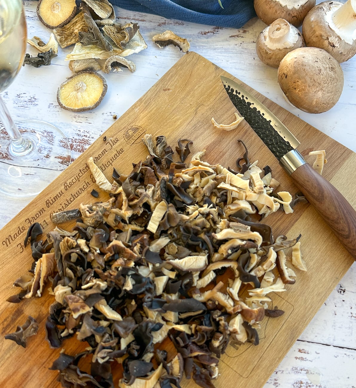 Sliced mushrooms on a cutting board for slow cooker risotto