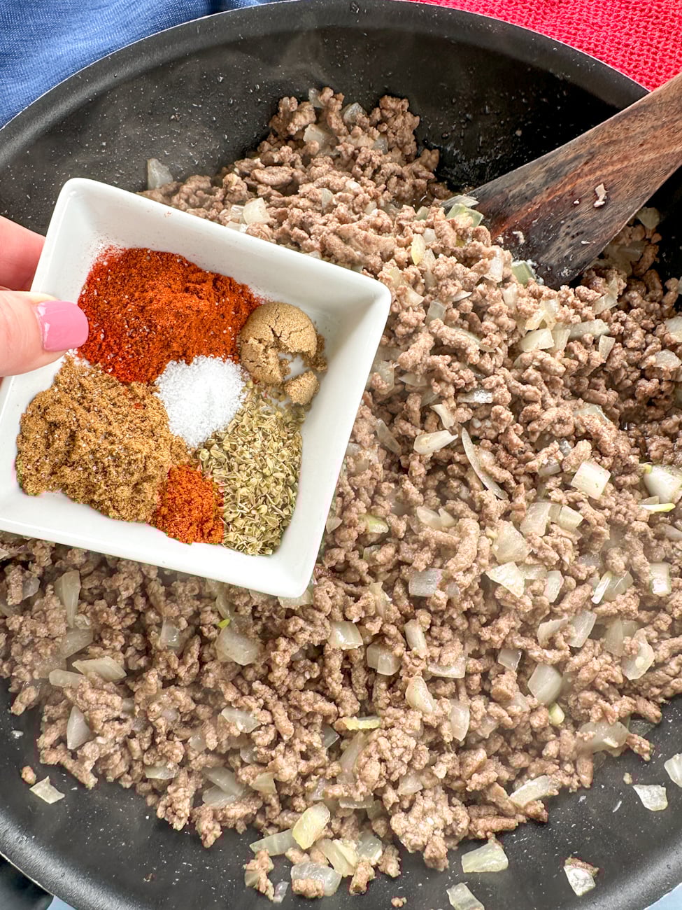 adding the spices to the mince for nacho chilli
