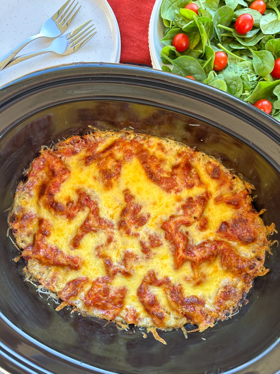 Freshly cooked melted cheese on a slow cooker spinach and ricotta lasagna