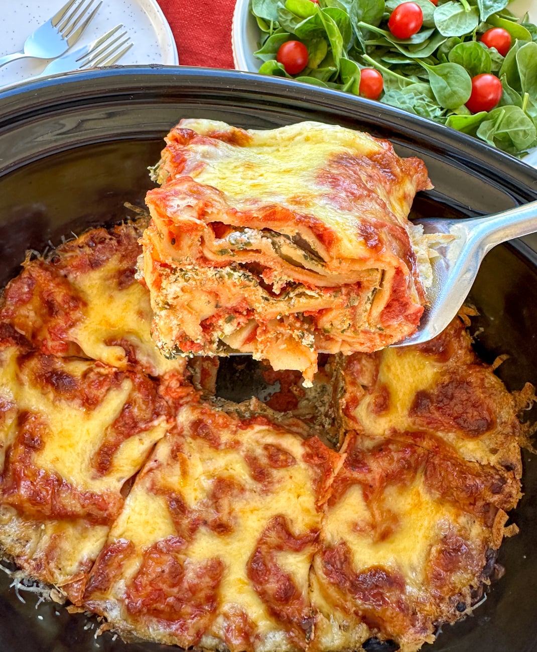Slice of ricotta and spinach lasagna in the slow cooker