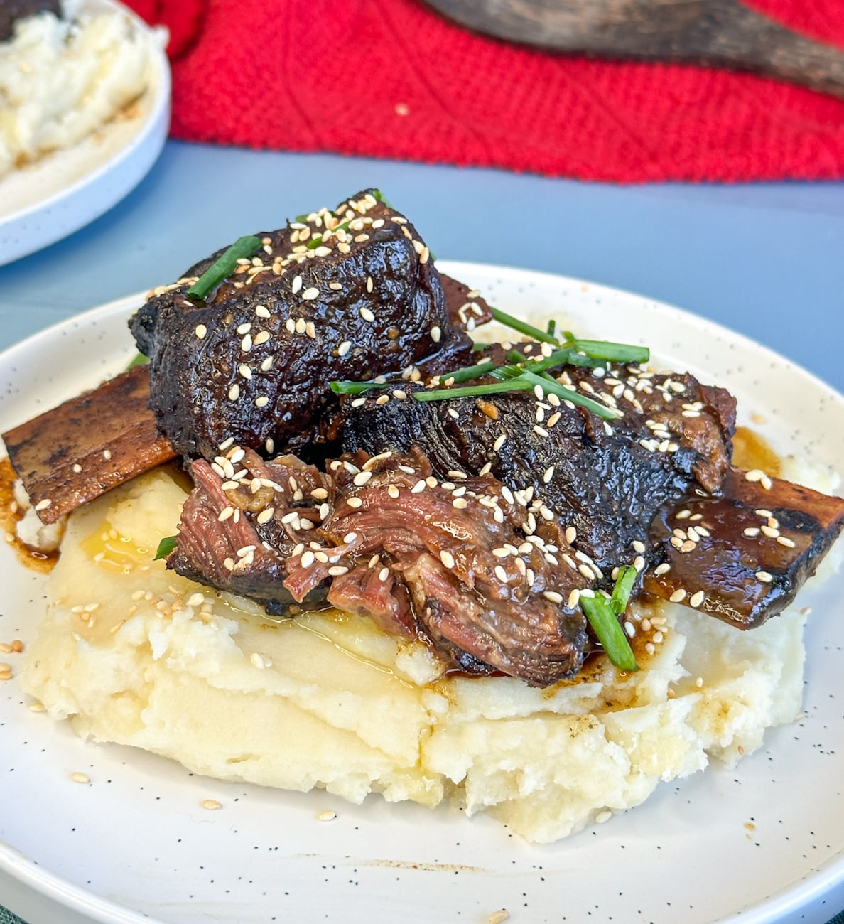 slow cooker sticky asian short ribs with rich gravy over mashed potato