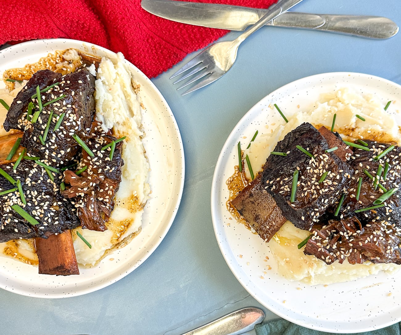 plates of sticky asian beef short ribs over mashed potato