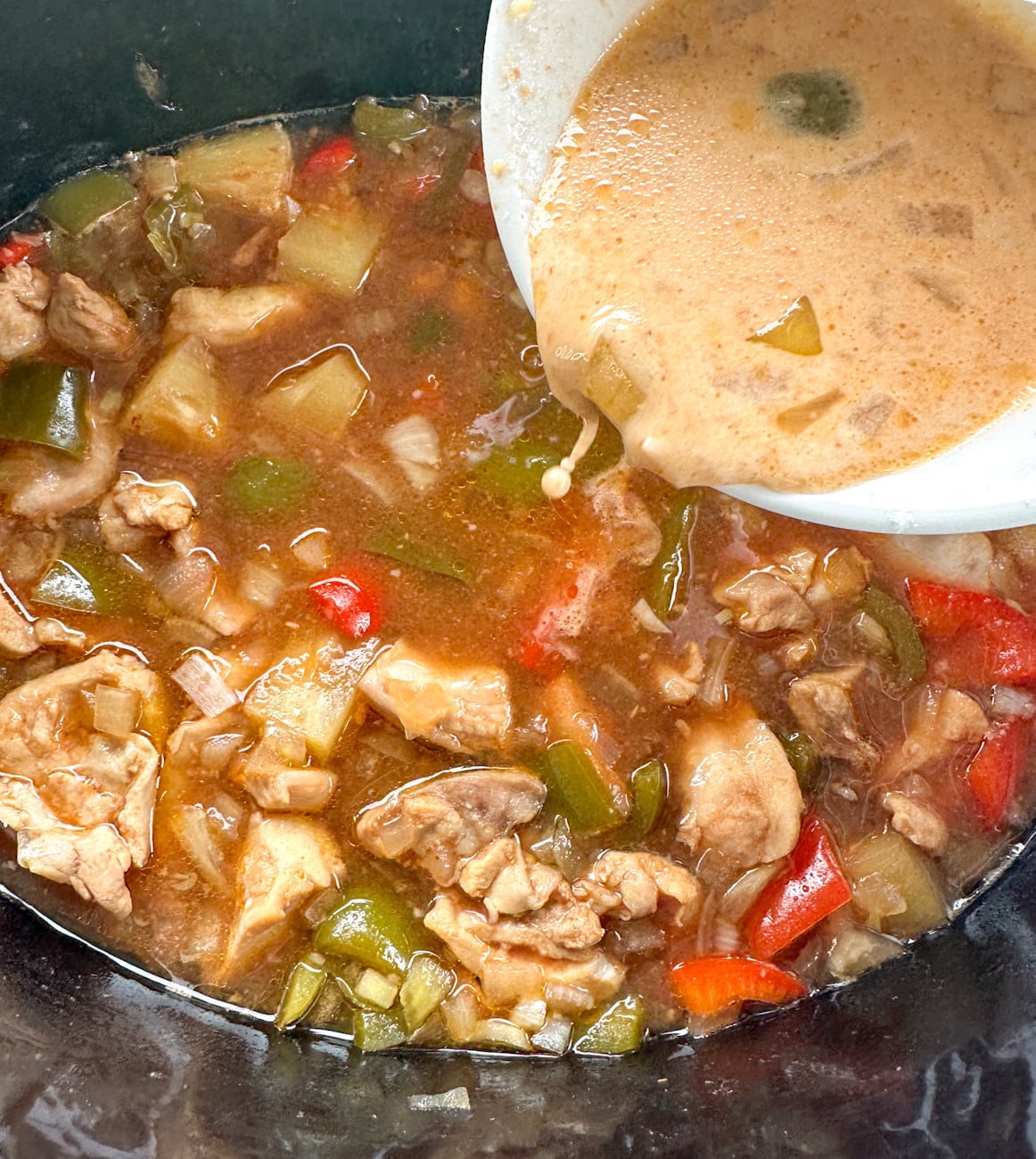 pouring in cornflour slurry into slow cooker