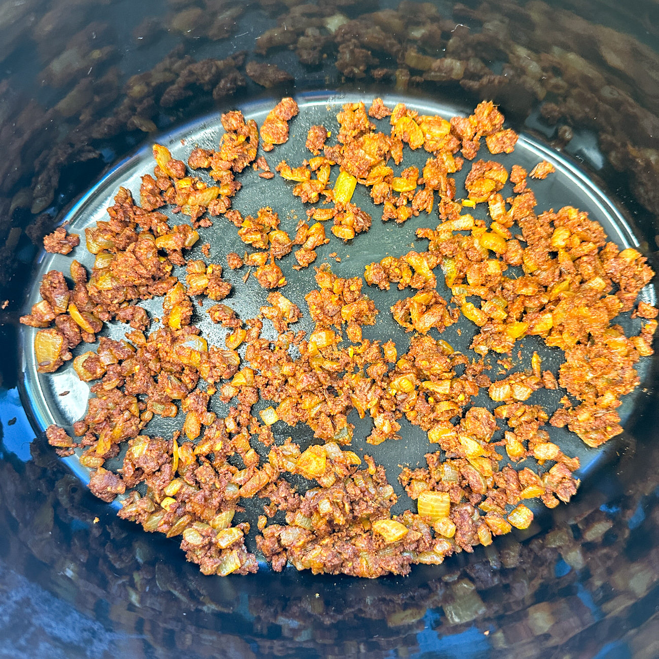 add the spiced onions to the bottom of the slow cooker