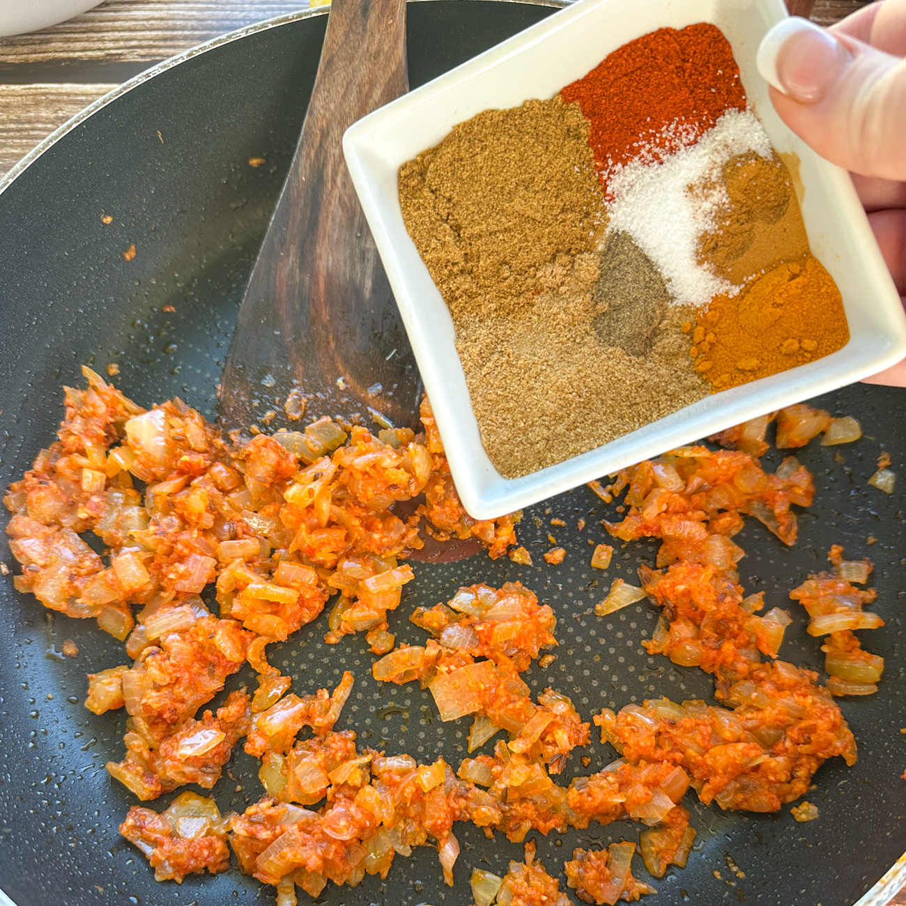 adding spices for moroccan tagine