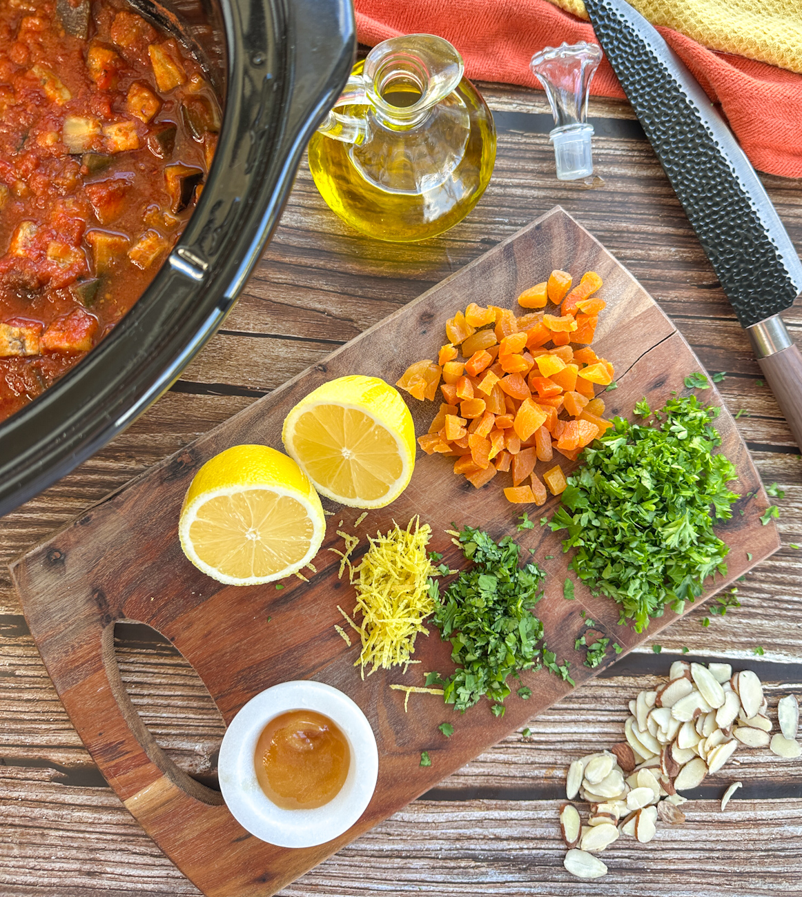 finishing ingredients for a Moroccan Tagine, lemons, fresh herbs, apricots, sliced almonds, olive oil