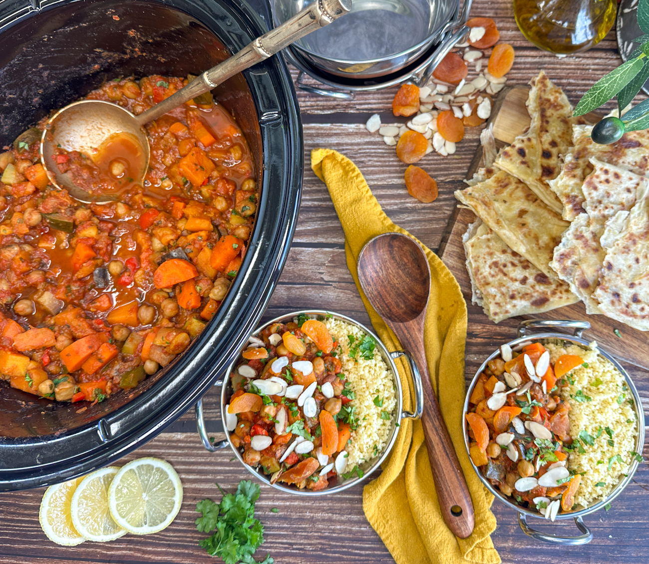 Slow cooker filled with moroccan vegetable tagine and some served in bowls