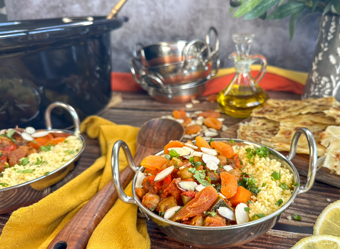bowl of moroccan vegetable tagine with couscous almonds and dried apricots