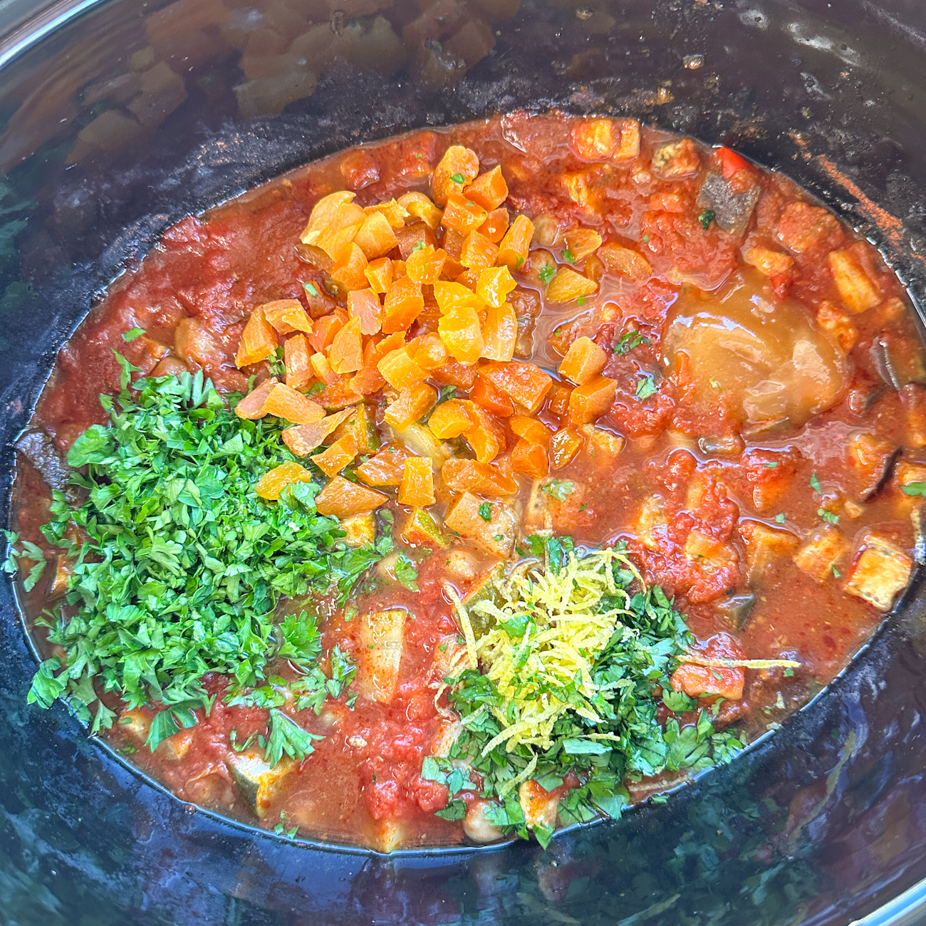 adding the finishing touches to the slow cooker tagine
