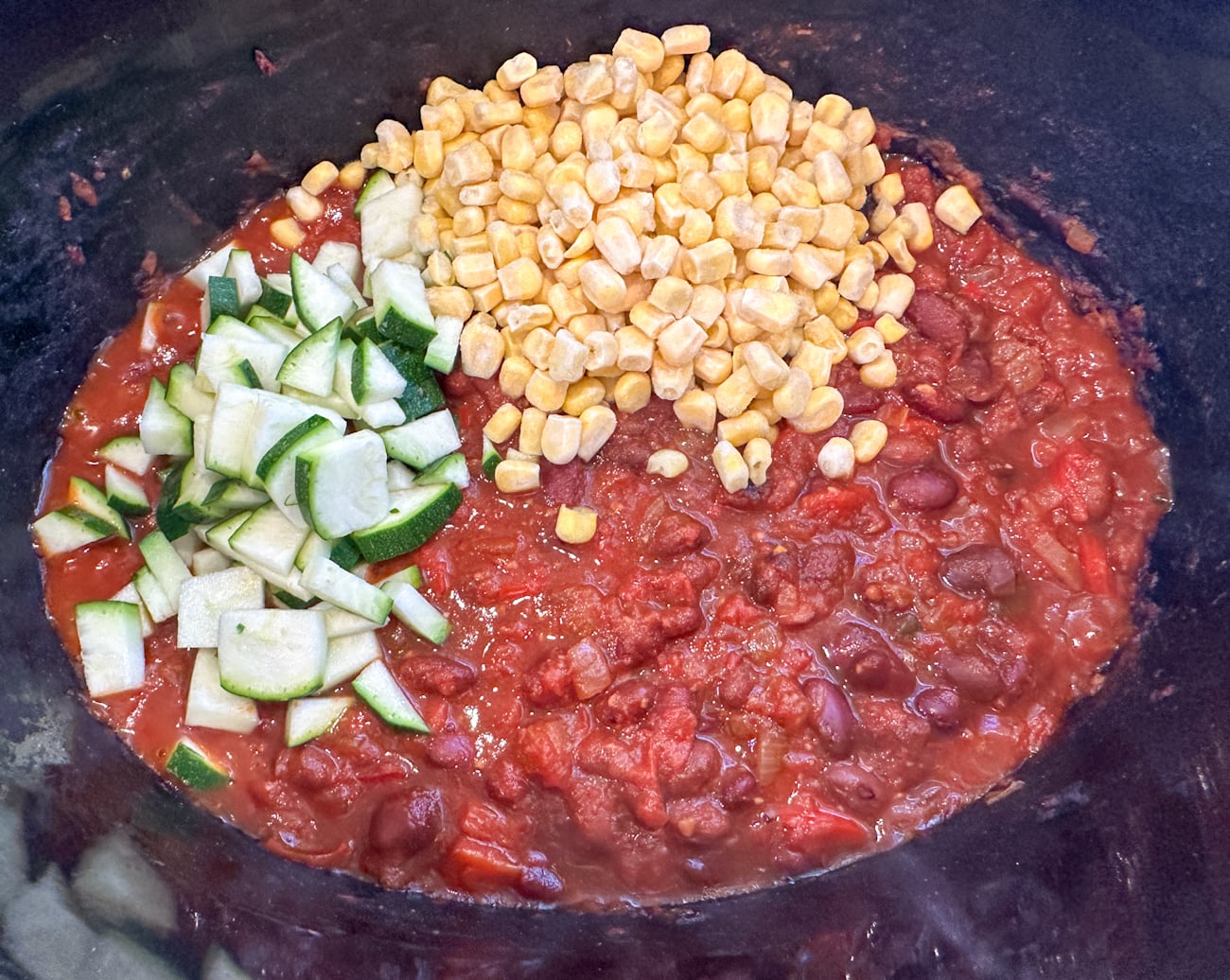 adding frozen corn and zucchini to the chili near end of cooking