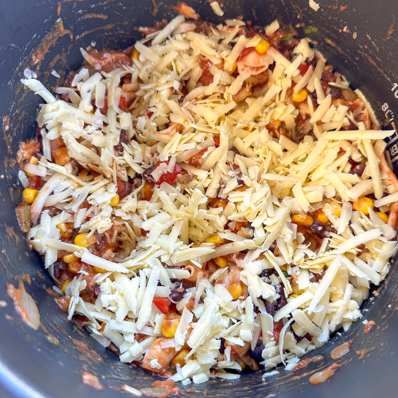 grated cheese on top of the enchilada casserole