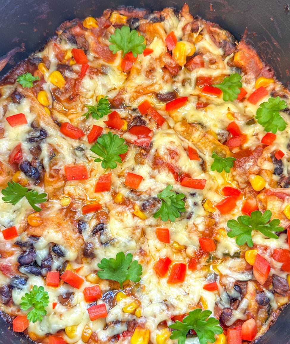 slow cooker filled with vegetarian enchilada casserole