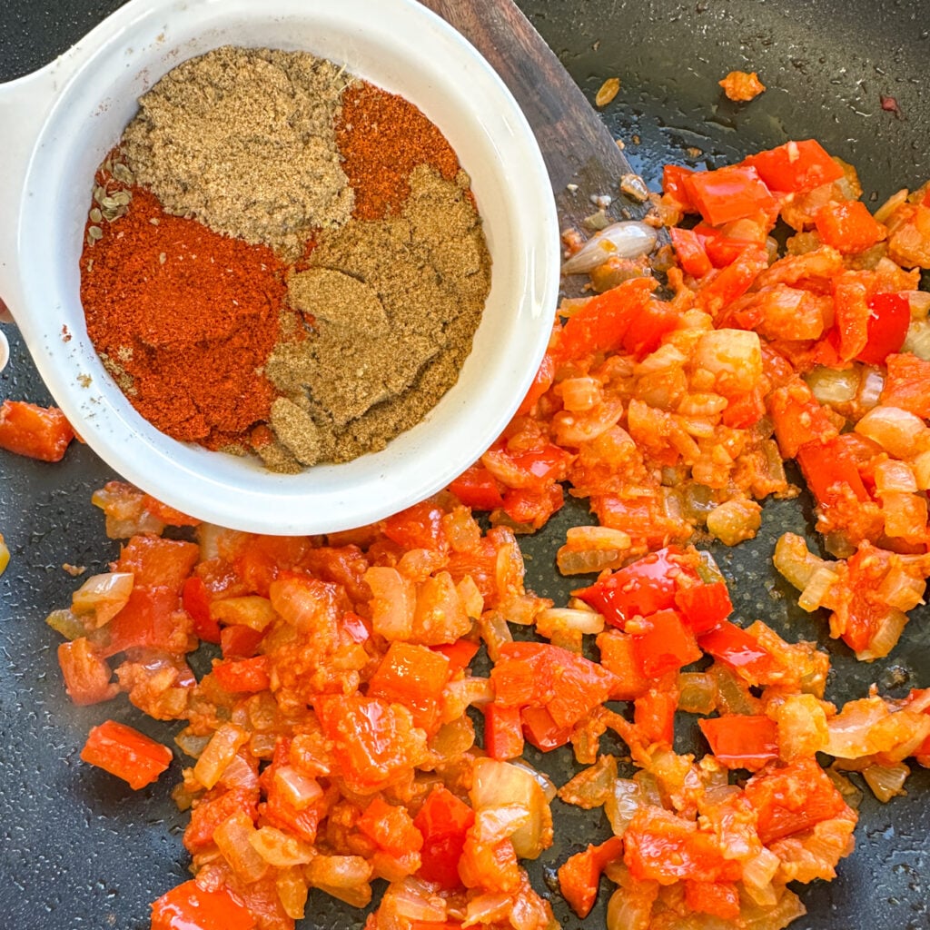 spices going into the frying pan