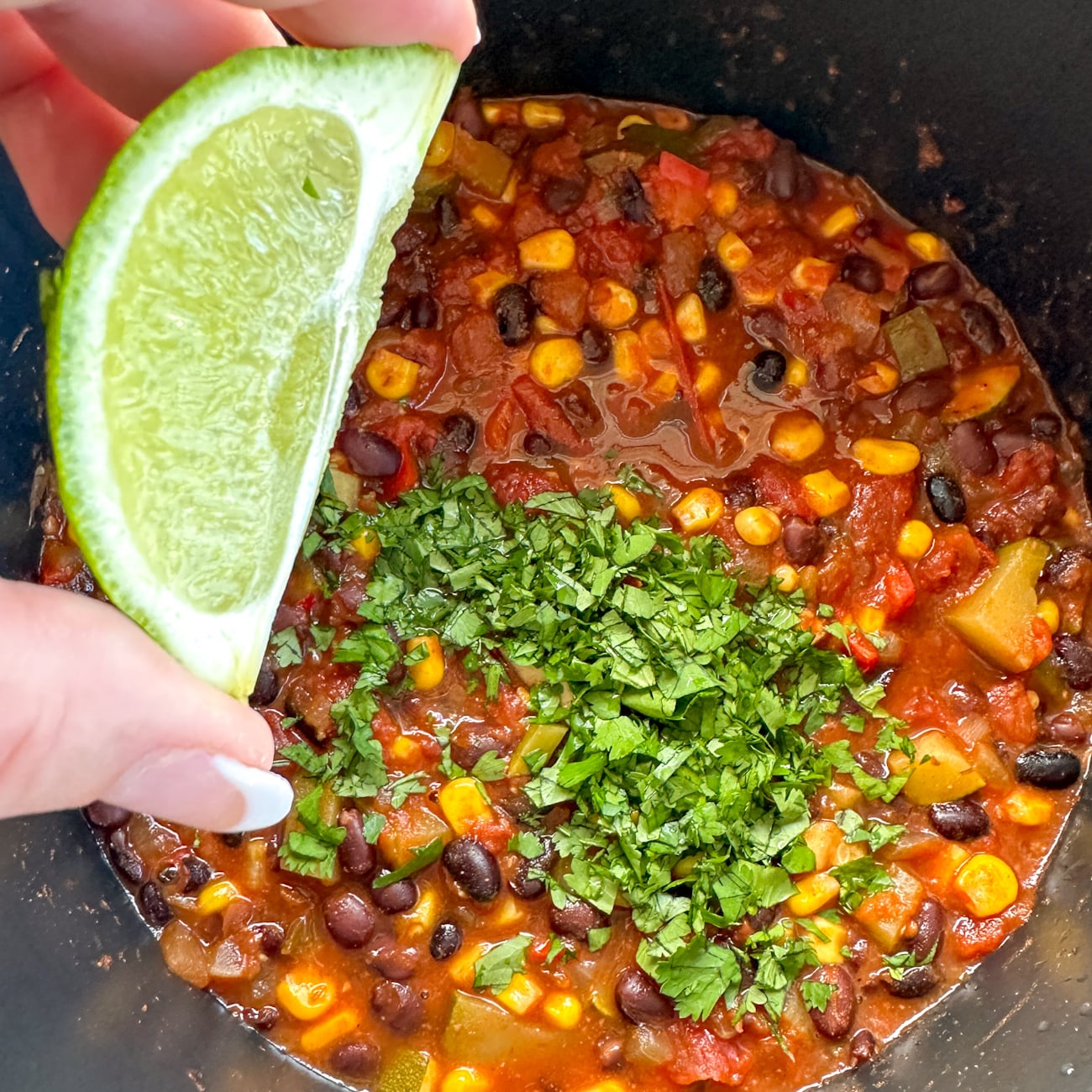 adding lemon and herbs to the enchilada casserole