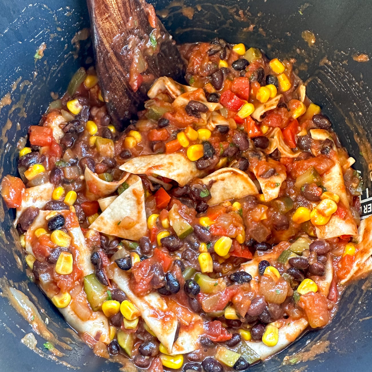 stirring the tortillas into the casserole