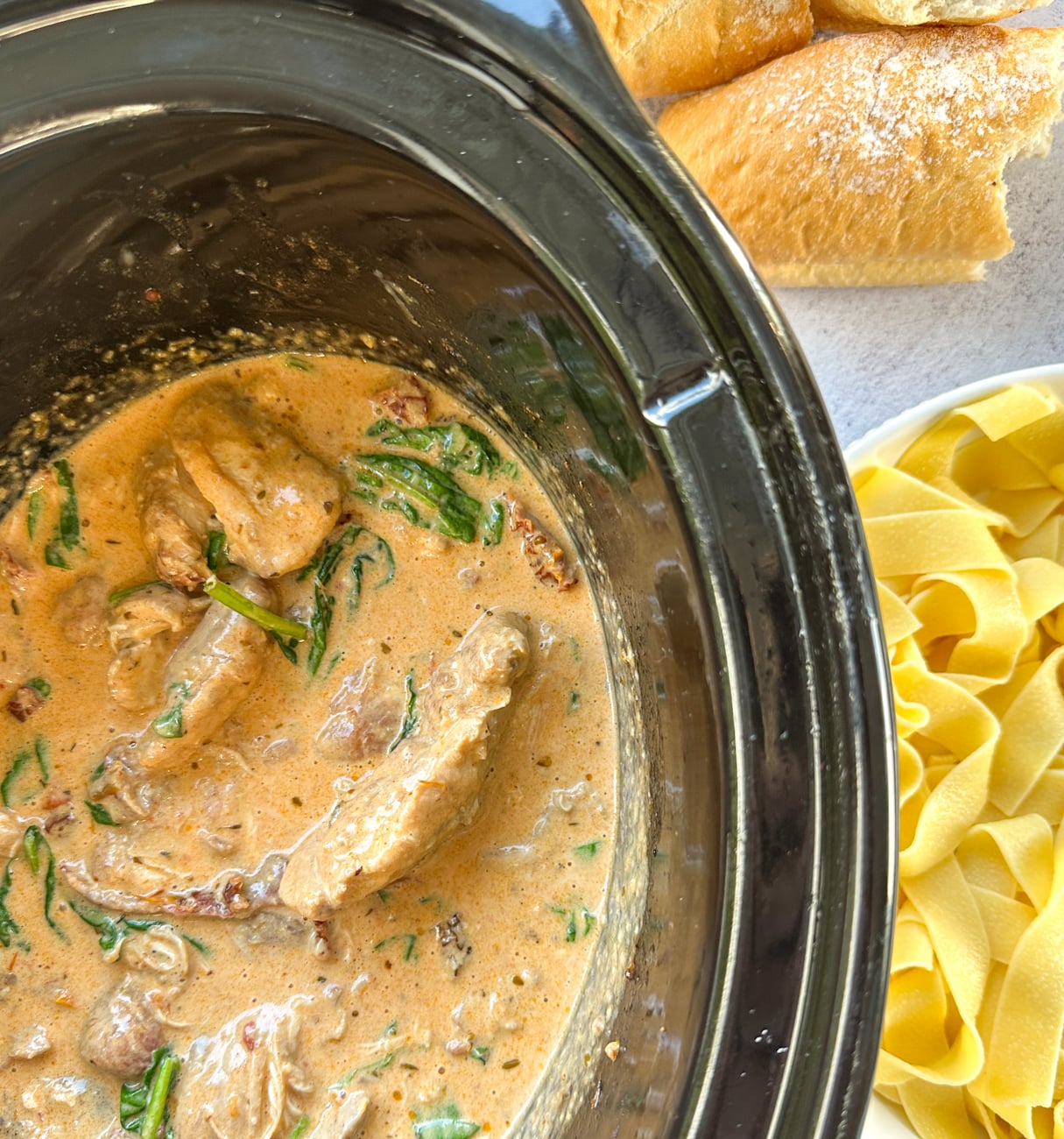slow cooker with creamy tuscan chicken