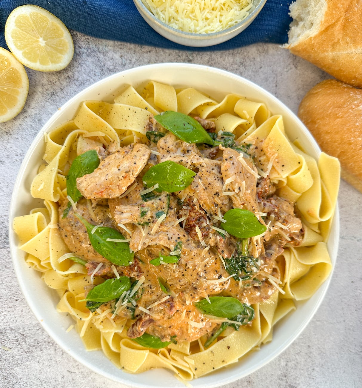 bowl of pappardelle with creamy tuscan chicken served over the top